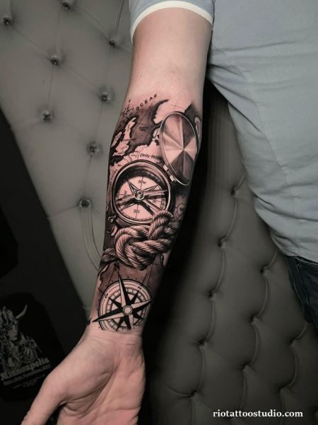 Realistic nautical half sleeve tattoo with compass, pocket watch, rope and world map on forearm
