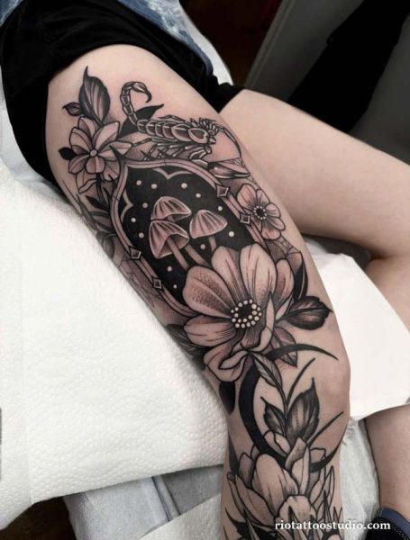 Black and grey floral leg sleeve with scorpion and mushrooms on thigh, dark floral leg sleeve tattoo ideas