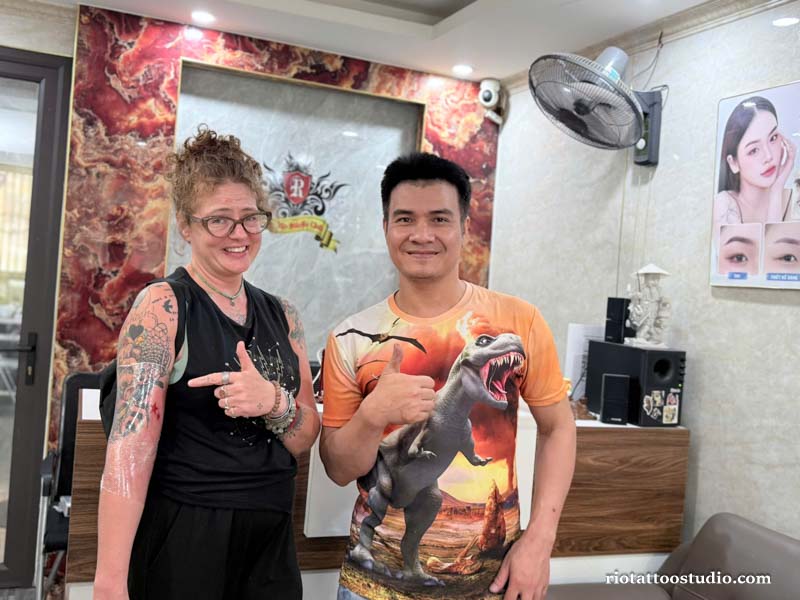 Happy foreign client smiling with her new stomach tattoo at Rio Studio