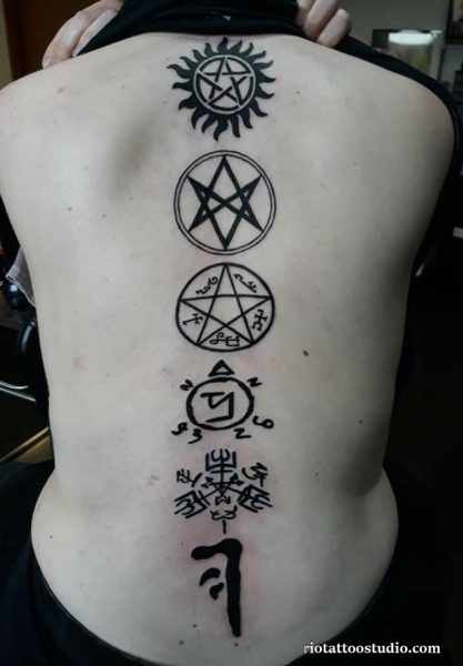 Vertical spine supernatural tattoo with stacked anti-demon pentagrams, angel banishing sigil and Enochian symbols, supernatural tattoo ideas