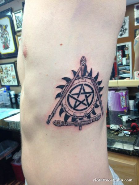 Supernatural anti-possession tattoo with angel blade, shotgun and pentagram on ribs, supernatural tattoo ideas