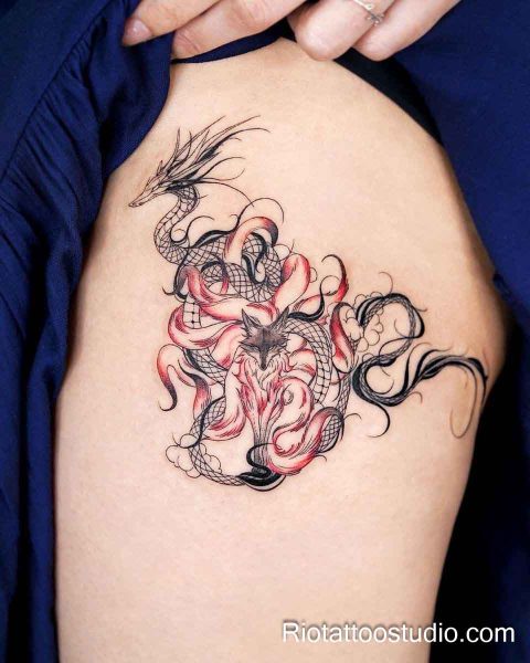 Japanese dragon and kitsune fox thigh tattoo with red and black flames on hip, thigh tattoo ideas