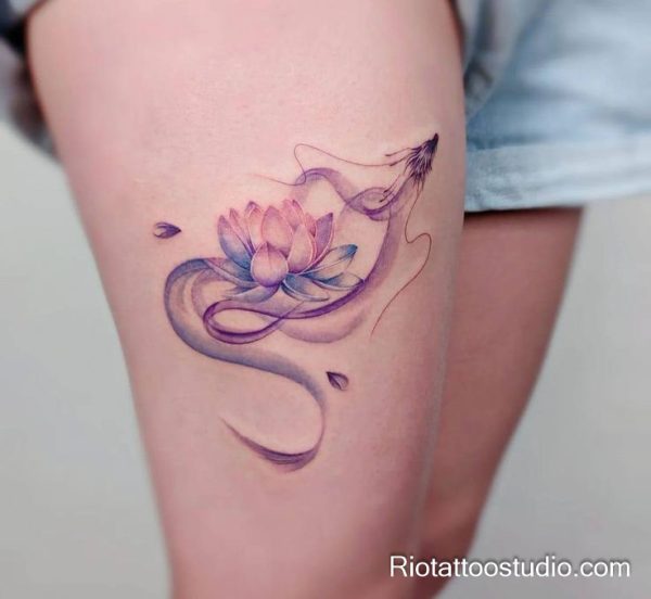 Watercolor lotus flower with purple dragon thigh tattoo in soft pastel tones, thigh tattoo ideas