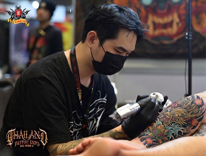 Tattoo Artist Anh Duc performing live tattoo artistry at Thailand Tattoo Convention
