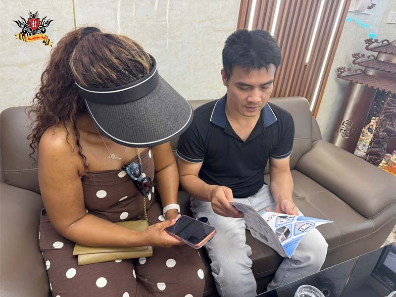 Professional artist consulting a client about card tattoo cost.