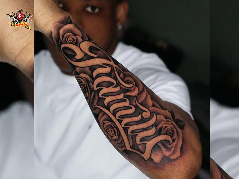 Chicano lettering tattoo combined with cultural symbols.