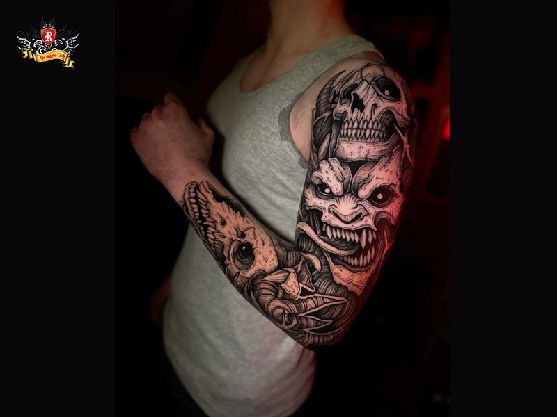 Full sleeve demon tattoo covering the arm and shoulder of a male client at Rio Tattoo Studio.