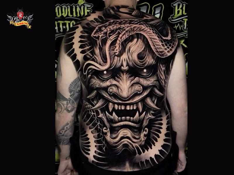 A large and detailed full back demon tattoo featuring an epic battle at Rio Tattoo Studio.