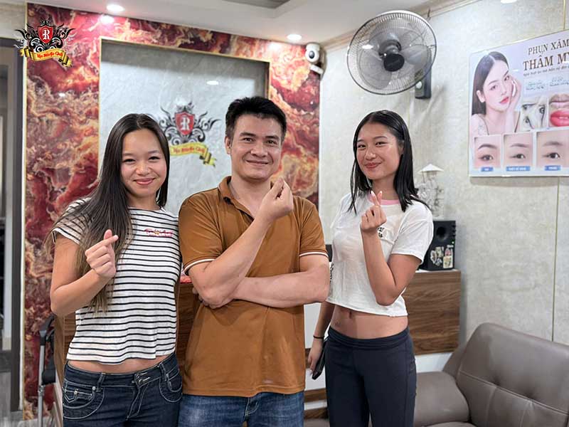 Rio Tattoo Studio artist posing with a happy customer after completing a session for feet tattoos for ladies.