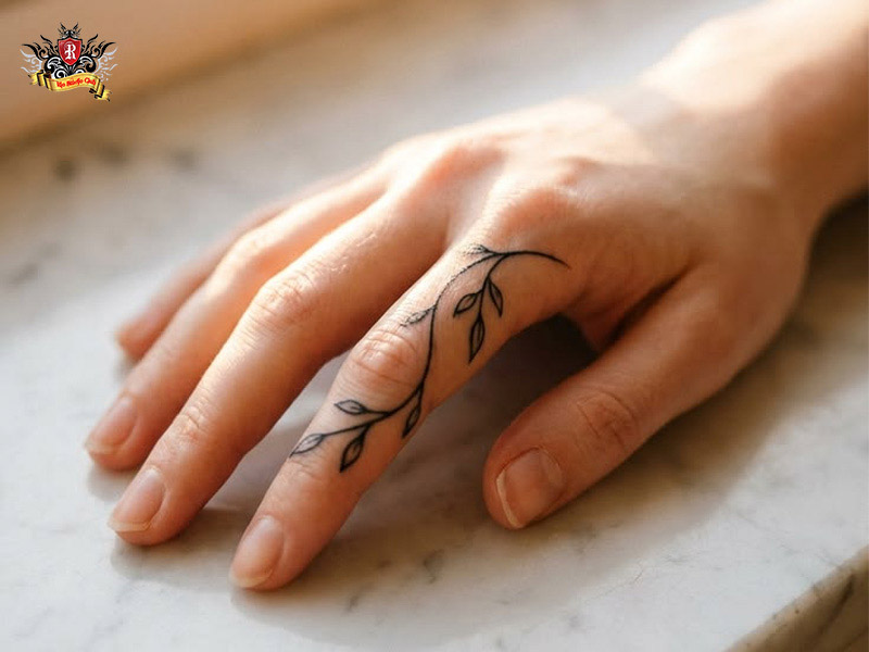 Close-up of a tiny inner index design showcasing a delicate finger tattoo for women at Rio Tattoo Studio.