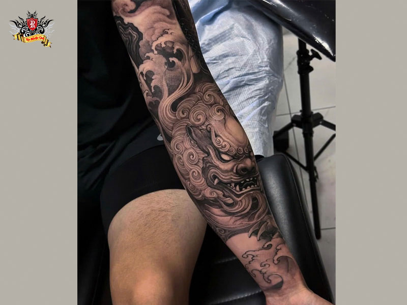 Full sleeve foo dragon tattoo with traditional Japanese clouds and waves at Rio Tattoo Studio.
