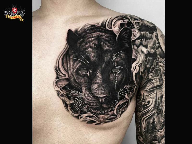 Large majestic black panther tattoo on a client's chest and back shoulder blade at Rio Tattoo Studio.