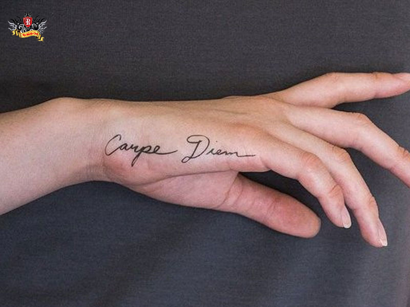 Meaningful text quote layout along the side hand of a girl showing unique small hand tattoos at Rio Tattoo Studio.