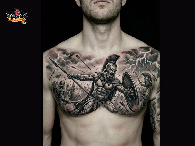 Large chest spartan tattoo of a realistic Greek warrior extending slightly onto the shoulder at Rio Tattoo Studio.