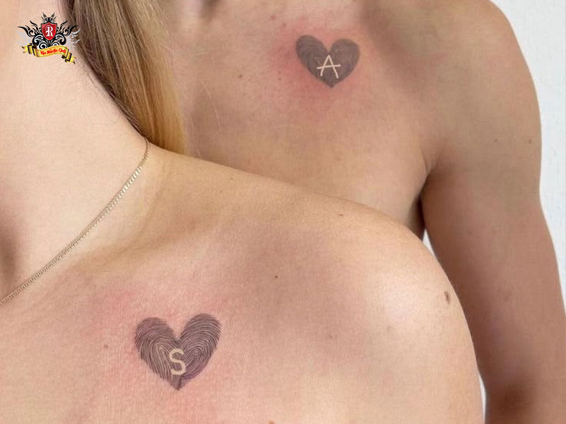 Subtle chest ink near the heart featuring name scripts as matching tattoos for wife and husband.