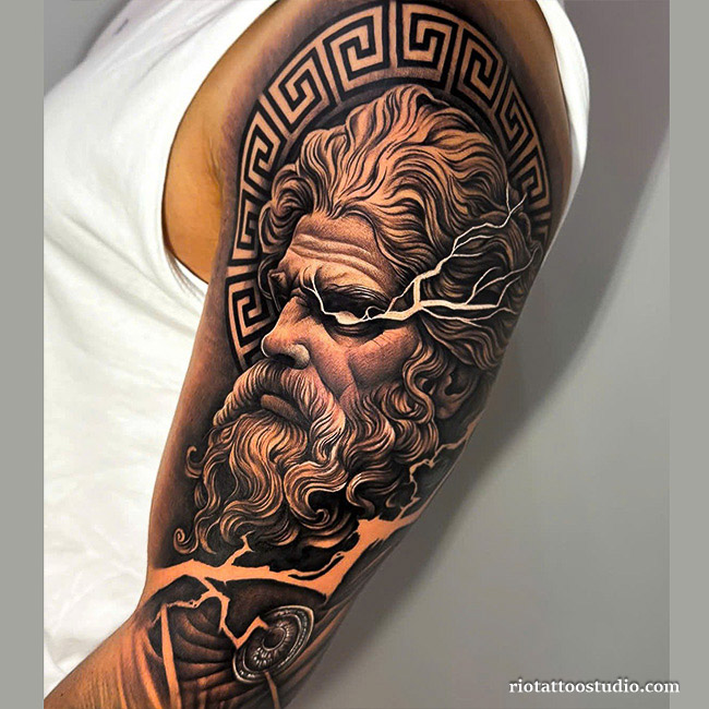 Realistic Zeus tattoo with Greek patterns.