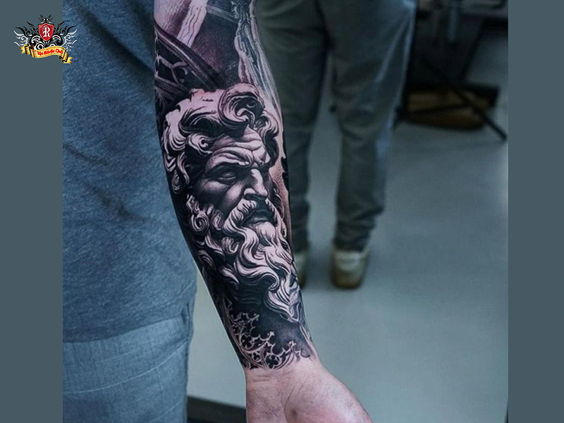 Forearm and shoulder tattoo of zeus.